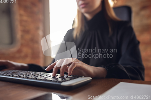 Image of Caucasian young woman in business attire working in office