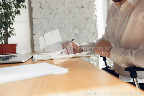 Image of Caucasian young man in business attire working in office, job, online studying