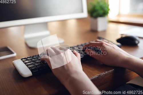 Image of Caucasian young woman in business attire working in office