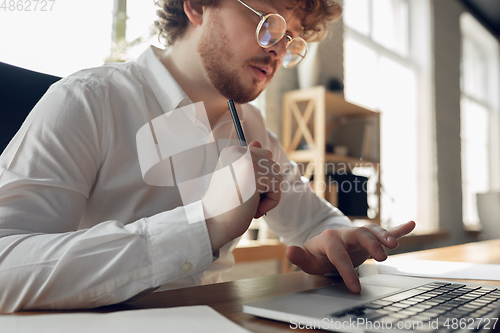 Image of Caucasian young man in business attire working in office, job, online studying