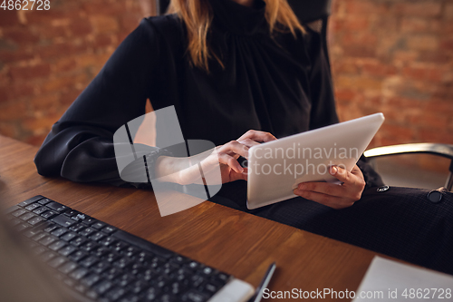 Image of Caucasian young woman in business attire working in office