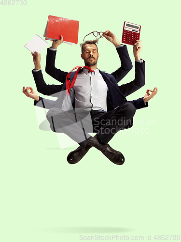 Image of Young caucasian businessman, manager who manages everything, a lot of things and deals