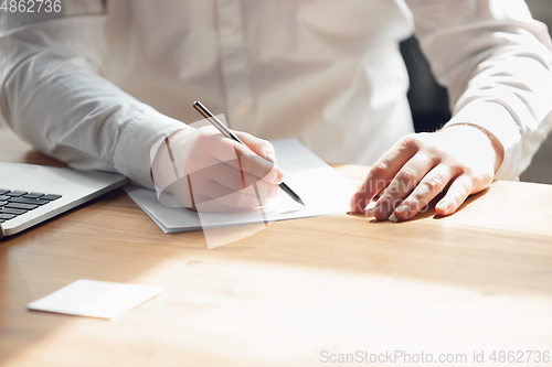 Image of Caucasian young man in business attire working in office, job, online studying