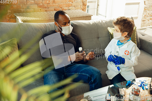 Image of Little caucasian boy as a doctor consulting for patient, working in cabinet, close up