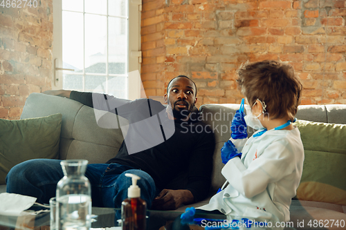 Image of Little caucasian boy as a doctor consulting for patient, working in cabinet, close up