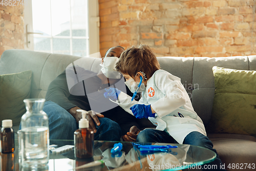 Image of Little caucasian boy as a doctor consulting for patient, working in cabinet, close up