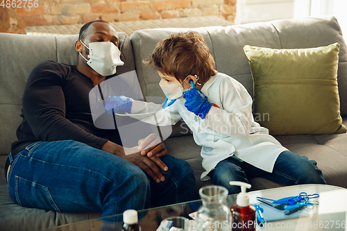 Image of Little caucasian boy as a doctor consulting for patient, working in cabinet, close up