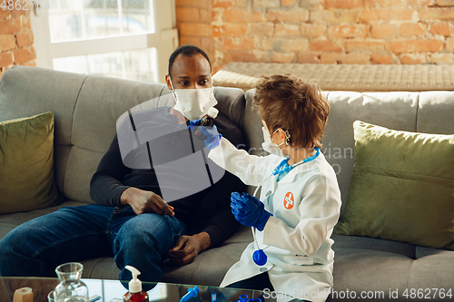 Image of Little caucasian boy as a doctor consulting for patient, working in cabinet, close up