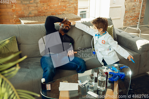 Image of Little caucasian boy as a doctor consulting for patient, working in cabinet, close up