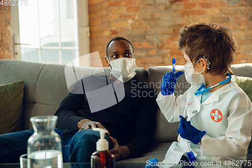 Image of Little caucasian boy as a doctor consulting for patient, working in cabinet, close up