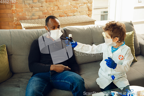 Image of Little caucasian boy as a doctor consulting for patient, working in cabinet, close up