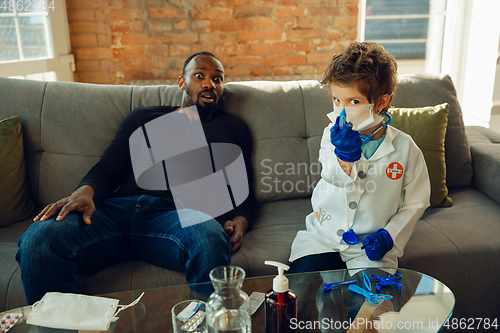 Image of Little caucasian boy as a doctor consulting for patient, working in cabinet, close up