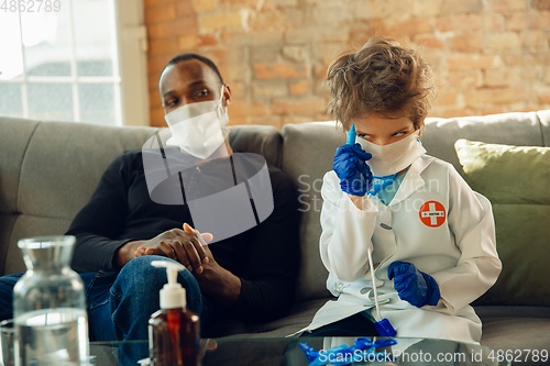 Image of Little caucasian boy as a doctor consulting for patient, working in cabinet, close up