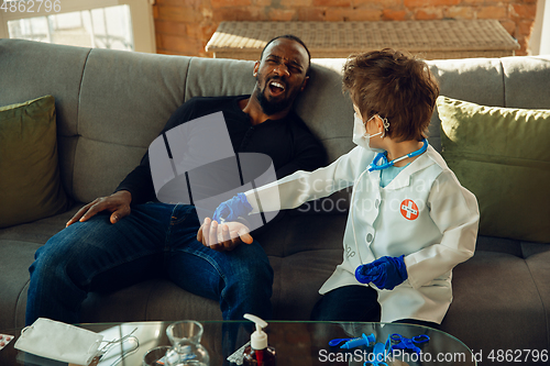 Image of Little caucasian boy as a doctor consulting for patient, working in cabinet, close up