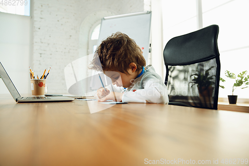 Image of Little caucasian boy as a doctor consulting for patient, working in cabinet, close up