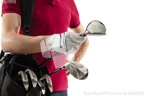 Image of Golf player in a red shirt training, practicing isolated on white studio background