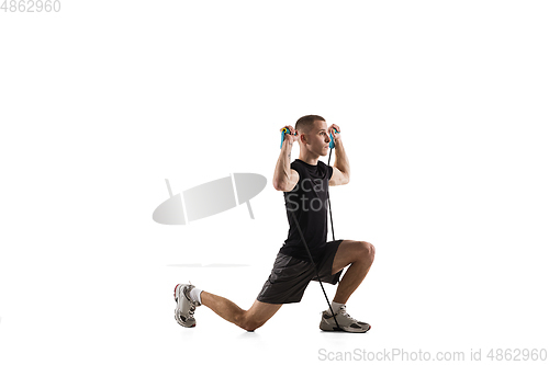 Image of Young caucasian male model in action, motion isolated on white background. Concept of sport, movement, energy and dynamic, healthy lifestyle. Training, practicing.