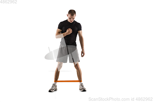 Image of Young caucasian male model in action, motion isolated on white background. Concept of sport, movement, energy and dynamic, healthy lifestyle. Training, practicing.
