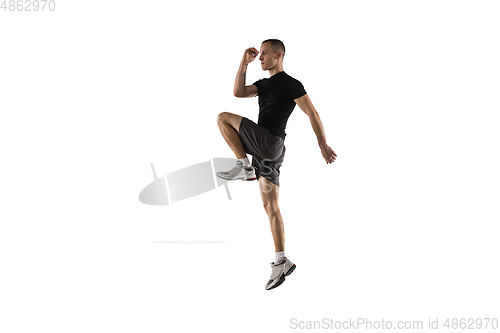 Image of Young caucasian male model in action, motion isolated on white background. Concept of sport, movement, energy and dynamic, healthy lifestyle. Training, practicing.