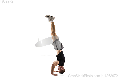 Image of Young caucasian male model in action, motion isolated on white background. Concept of sport, movement, energy and dynamic, healthy lifestyle. Training, practicing.