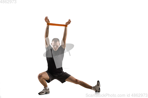 Image of Young caucasian male model in action, motion isolated on white background. Concept of sport, movement, energy and dynamic, healthy lifestyle. Training, practicing.