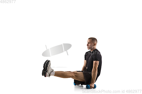 Image of Young caucasian male model in action, motion isolated on white background. Concept of sport, movement, energy and dynamic, healthy lifestyle. Training, practicing.