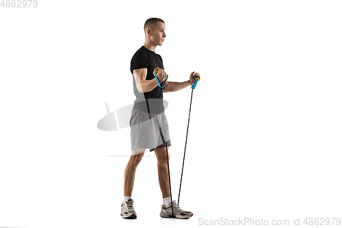 Image of Young caucasian male model in action, motion isolated on white background. Concept of sport, movement, energy and dynamic, healthy lifestyle. Training, practicing.