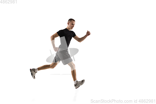 Image of Young caucasian male model in action, motion isolated on white background. Concept of sport, movement, energy and dynamic, healthy lifestyle. Training, practicing.