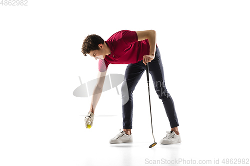 Image of Golf player in a red shirt training, practicing isolated on white studio background