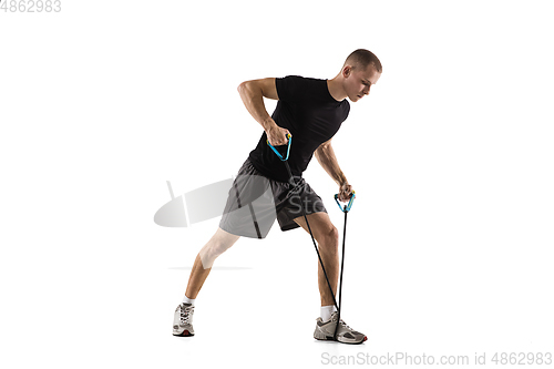 Image of Young caucasian male model in action, motion isolated on white background. Concept of sport, movement, energy and dynamic, healthy lifestyle. Training, practicing.