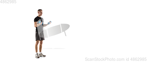 Image of Young caucasian male model in action, motion isolated on white background. Concept of sport, movement, energy and dynamic, healthy lifestyle. Training, practicing.