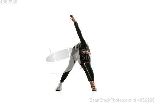 Image of Young caucasian female model in action, motion isolated on white background. Concept of sport, movement, energy and dynamic, healthy lifestyle. Training, practicing.