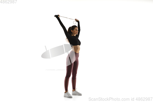 Image of Young caucasian female model in action, motion isolated on white background. Concept of sport, movement, energy and dynamic, healthy lifestyle. Training, practicing.