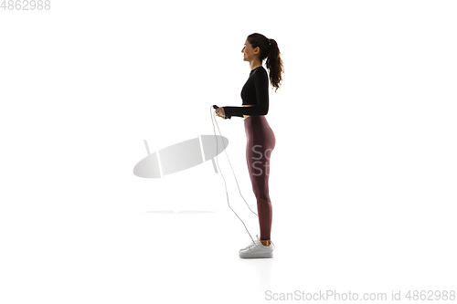 Image of Young caucasian female model in action, motion isolated on white background. Concept of sport, movement, energy and dynamic, healthy lifestyle. Training, practicing.