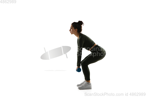 Image of Young caucasian female model in action, motion isolated on white background. Concept of sport, movement, energy and dynamic, healthy lifestyle. Training, practicing.