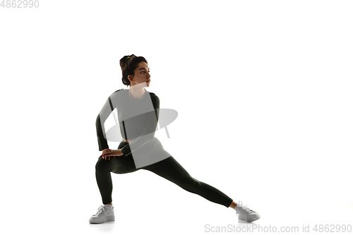 Image of Young caucasian female model in action, motion isolated on white background. Concept of sport, movement, energy and dynamic, healthy lifestyle. Training, practicing.