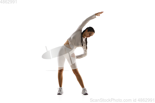 Image of Young caucasian female model in action, motion isolated on white background. Concept of sport, movement, energy and dynamic, healthy lifestyle. Training, practicing.