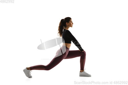 Image of Young caucasian female model in action, motion isolated on white background. Concept of sport, movement, energy and dynamic, healthy lifestyle. Training, practicing.