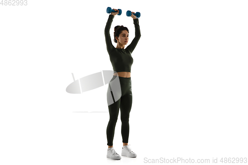 Image of Young caucasian female model in action, motion isolated on white background. Concept of sport, movement, energy and dynamic, healthy lifestyle. Training, practicing.