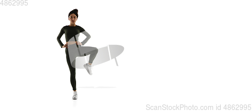 Image of Young caucasian female model in action, motion isolated on white background. Concept of sport, movement, energy and dynamic, healthy lifestyle. Training, practicing.