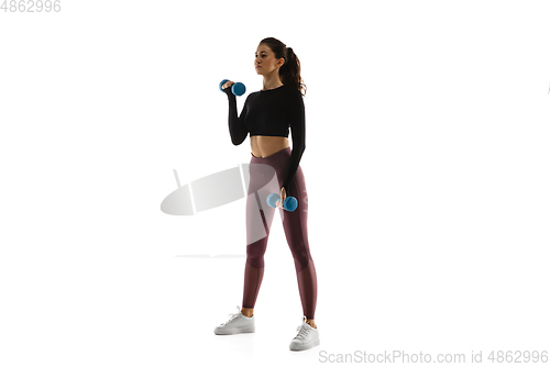 Image of Young caucasian female model in action, motion isolated on white background. Concept of sport, movement, energy and dynamic, healthy lifestyle. Training, practicing.