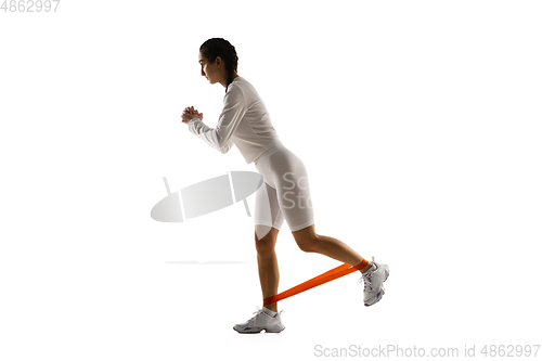 Image of Young caucasian female model in action, motion isolated on white background. Concept of sport, movement, energy and dynamic, healthy lifestyle. Training, practicing.