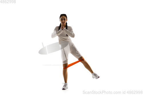 Image of Young caucasian female model in action, motion isolated on white background. Concept of sport, movement, energy and dynamic, healthy lifestyle. Training, practicing.