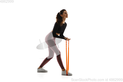 Image of Young caucasian female model in action, motion isolated on white background. Concept of sport, movement, energy and dynamic, healthy lifestyle. Training, practicing.