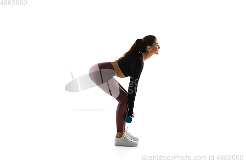 Image of Young caucasian female model in action, motion isolated on white background. Concept of sport, movement, energy and dynamic, healthy lifestyle. Training, practicing.