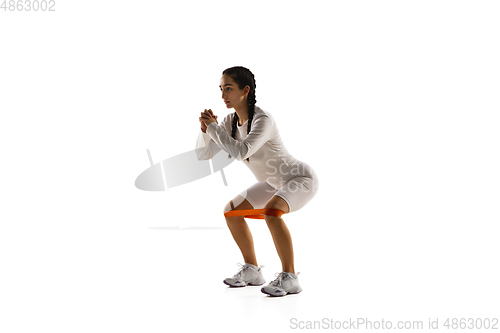 Image of Young caucasian female model in action, motion isolated on white background. Concept of sport, movement, energy and dynamic, healthy lifestyle. Training, practicing.