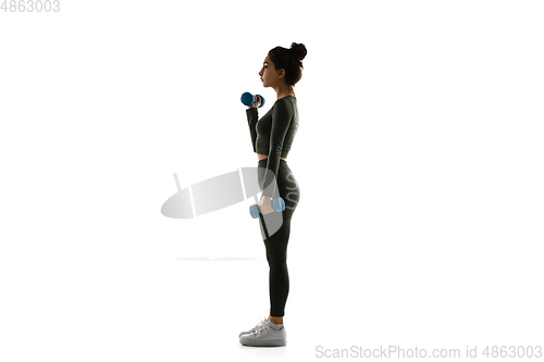 Image of Young caucasian female model in action, motion isolated on white background. Concept of sport, movement, energy and dynamic, healthy lifestyle. Training, practicing.