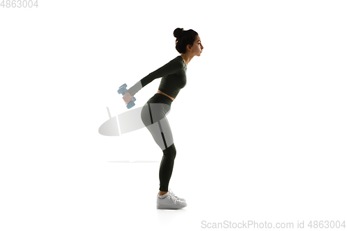 Image of Young caucasian female model in action, motion isolated on white background. Concept of sport, movement, energy and dynamic, healthy lifestyle. Training, practicing.