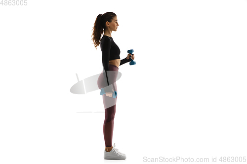 Image of Young caucasian female model in action, motion isolated on white background. Concept of sport, movement, energy and dynamic, healthy lifestyle. Training, practicing.