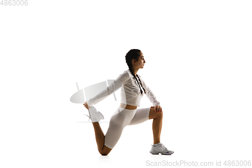 Image of Young caucasian female model in action, motion isolated on white background. Concept of sport, movement, energy and dynamic, healthy lifestyle. Training, practicing.